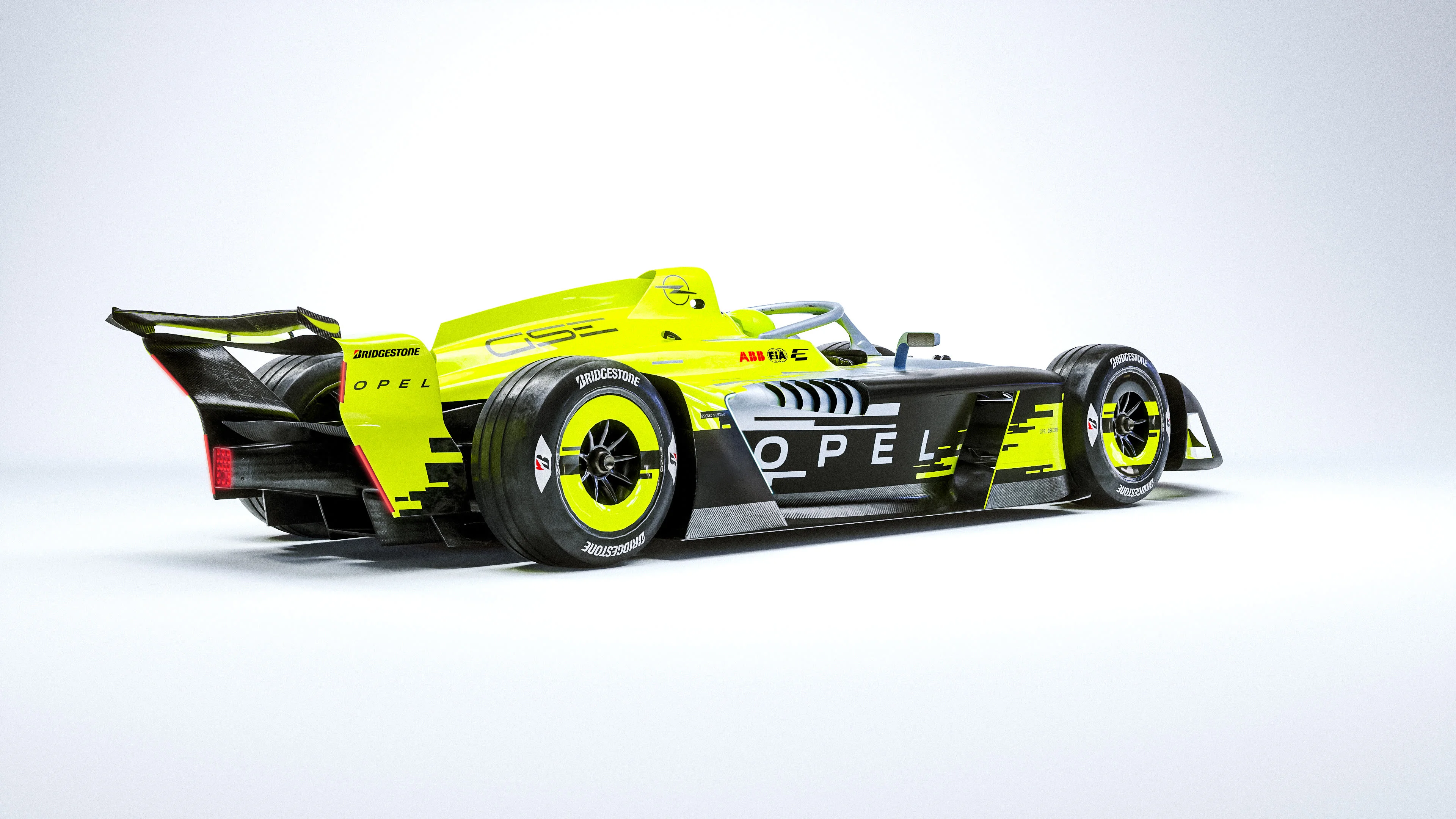 Rear three-quarter view of the yellow, silver and black Opel GSE 27FE Formula E car on a plain white studio background, with "OPEL" on the sidepod and rear wing.