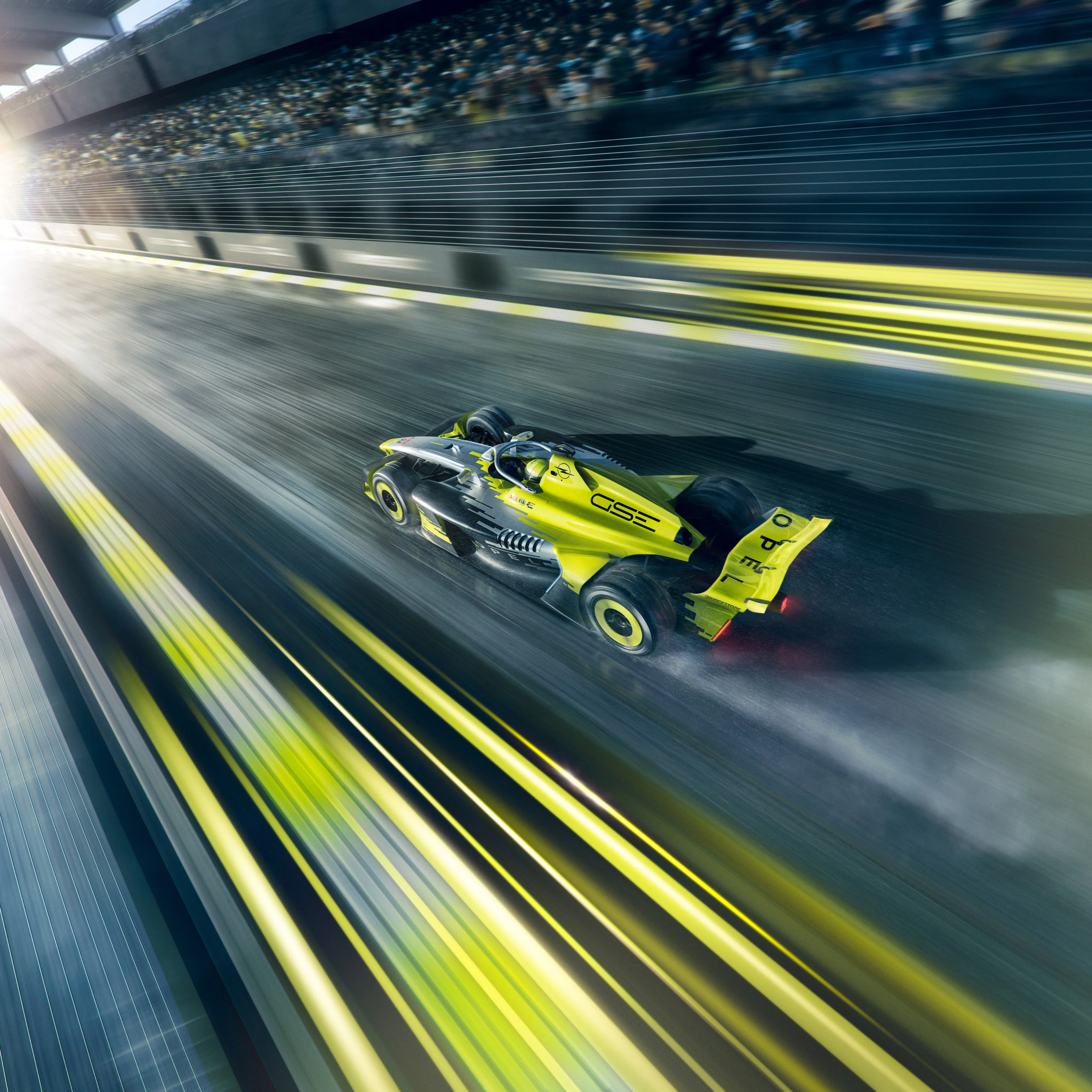 Neon yellow and black Opel GSE Formula E car seen from above and behind at speed on a wet track, spray rising from the rear wheels, with the kerbs and a packed grandstand streaked by motion blur.